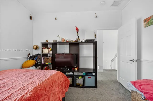 a bed room with a bed and a television