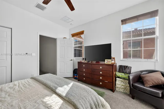 a bedroom with a bed and a television