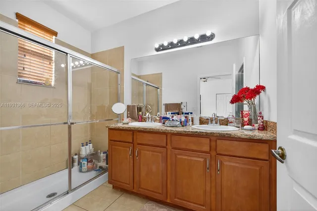 a bathroom with a sink vanity and a mirror