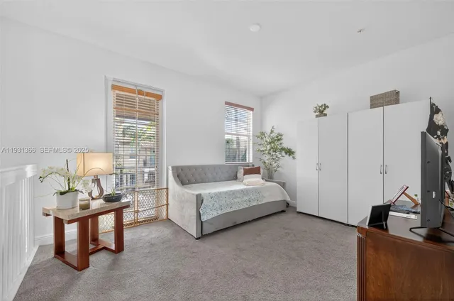 a spacious bedroom with a bed and a couch