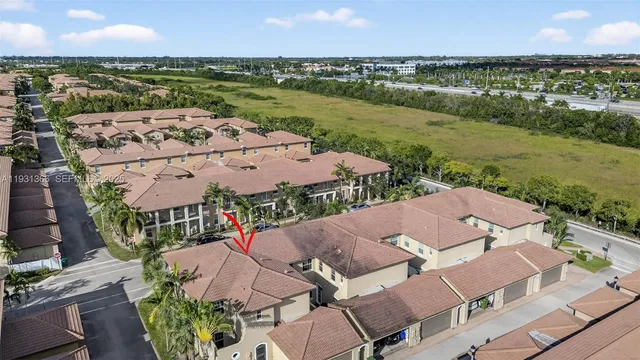 an aerial view of residential houses with outdoor space and river