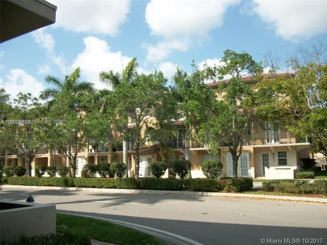 a city street lined with buildings and trees