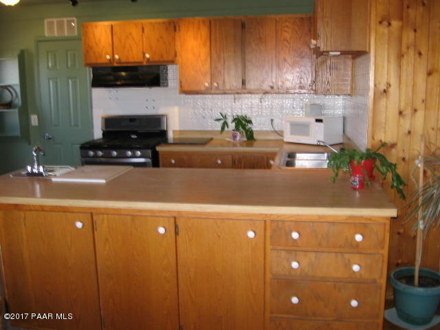 1120 North Moon Shadow Road Chino Valley, AZ 86323 - Photo 11 of 18 a living room with furniture and a potted plant