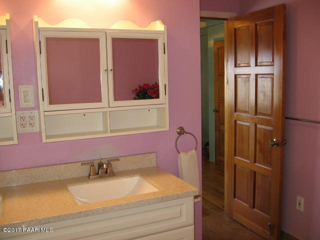 1120 North Moon Shadow Road Chino Valley, AZ 86323 - Photo 6 of 18 a bathroom with a granite countertop sink and mirror