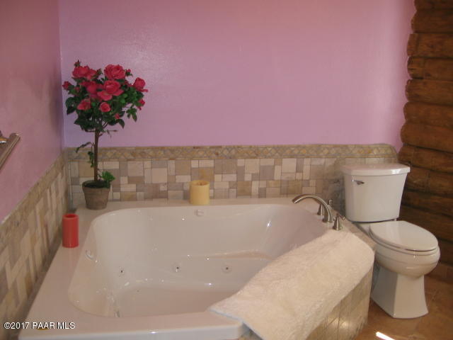 1120 North Moon Shadow Road Chino Valley, AZ 86323 - Photo 7 of 18 a white bath tub sitting in a bathroom next to a white wall