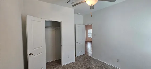 en view of an empty room with a ceiling fan