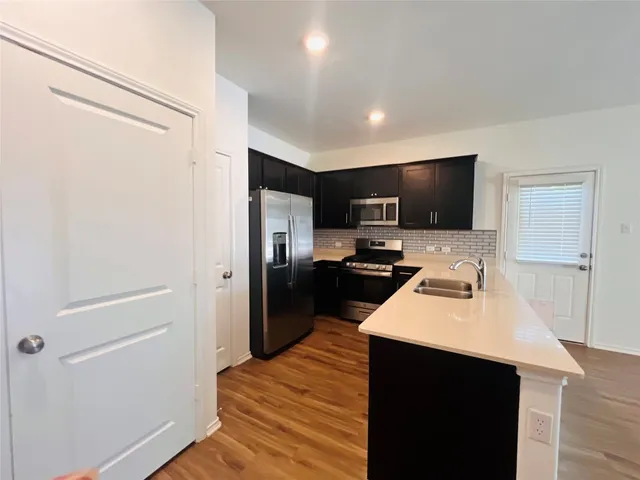 a bathroom with a toilet a sink and shower