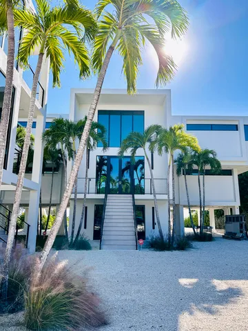 a front view of house with yard and car parked