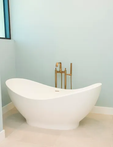 a bathroom with a granite countertop sink a toilet a mirror and shower