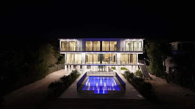 a living room with a floor to ceiling window and a fireplace