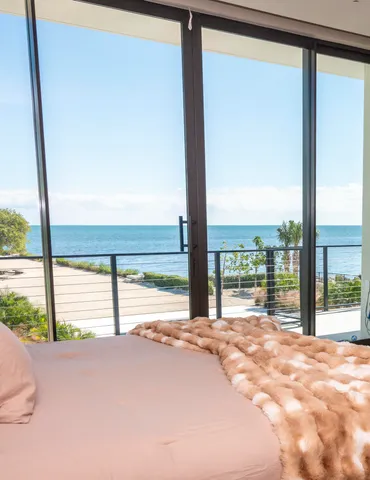 an aerial view of a house with porch and garden