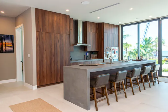a kitchen with a table chairs sink and cabinets