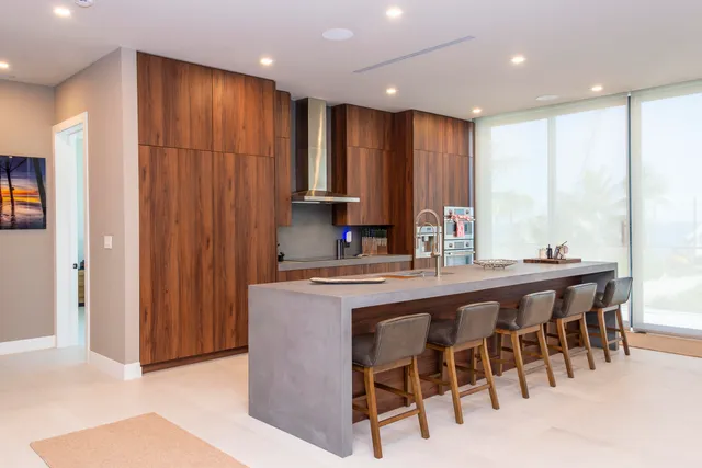 a kitchen with a sink a refrigerator and cabinets