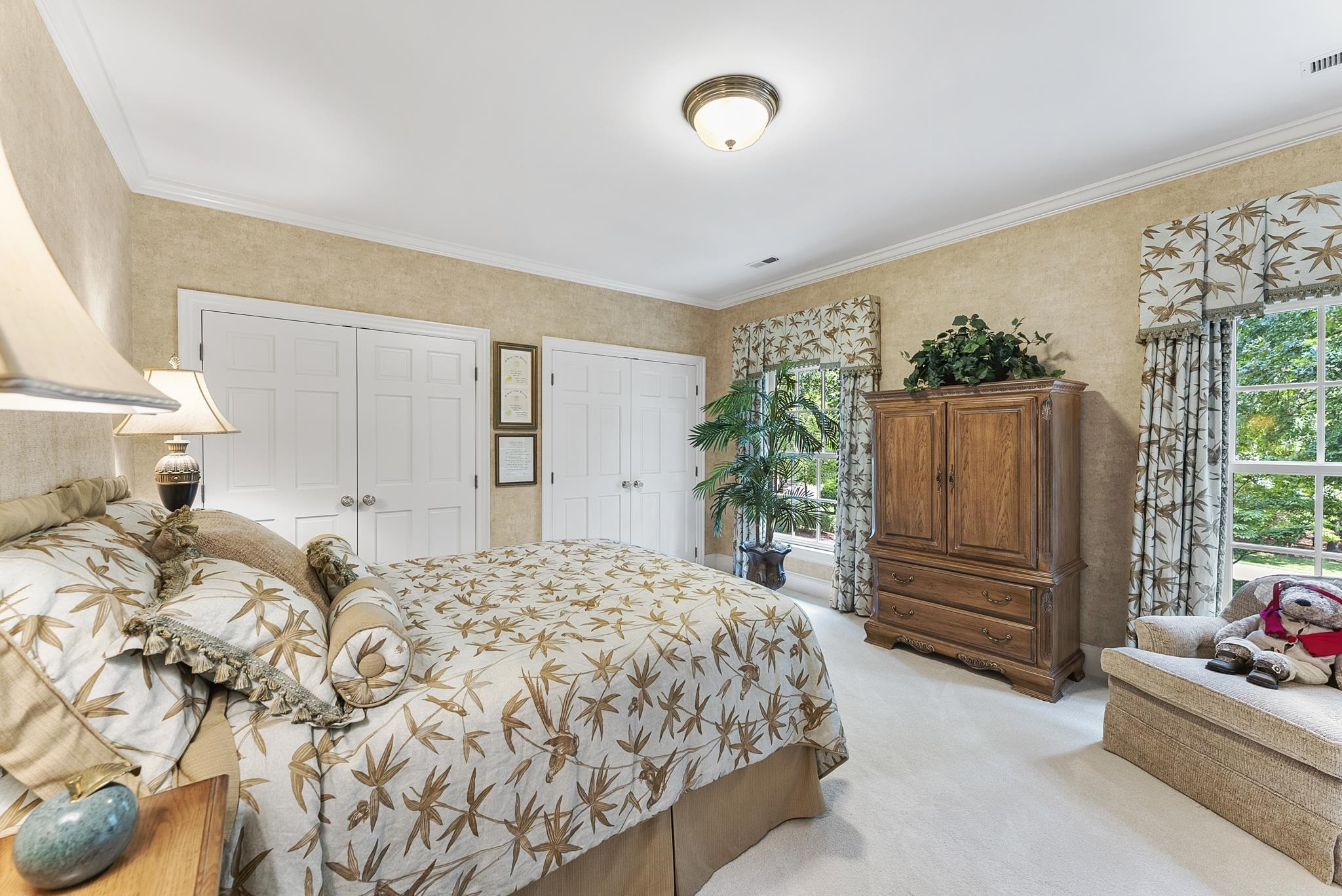 204 Carpathian Way Raleigh, NC 27615 - Photo 54 of 83 a bedroom with a bed and a potted plant