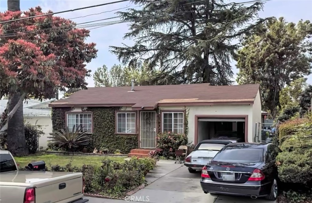 a front view of a house with a garden and plants