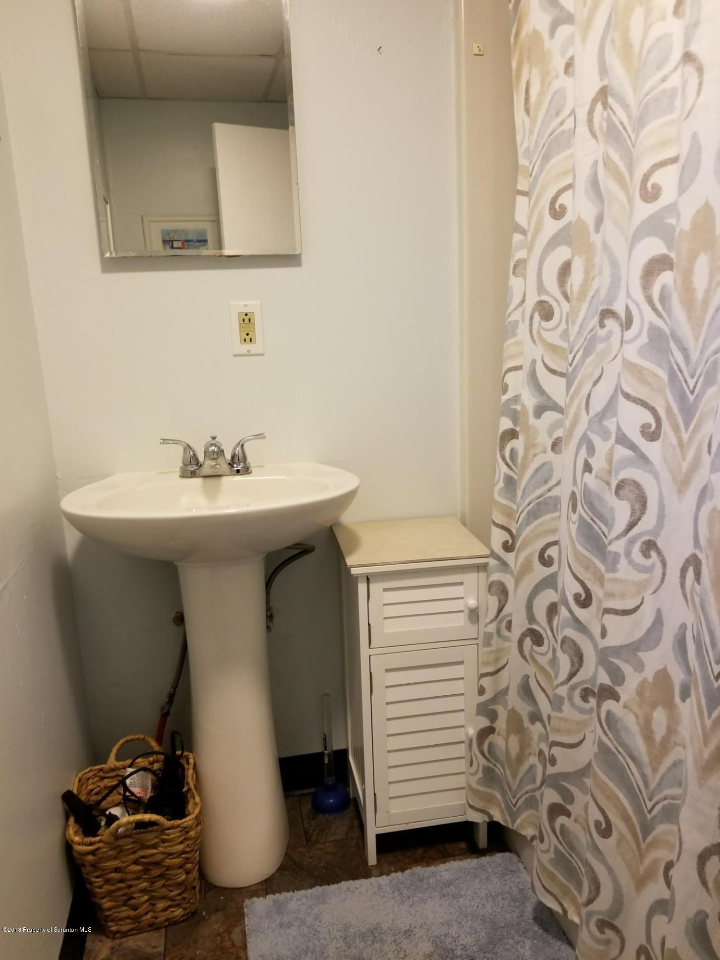 607 Spring Street Moosic, PA 18507 - Photo 9 of 24 a bathroom with a sink toilet and mirror