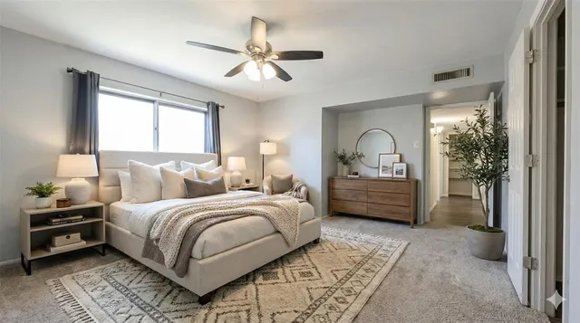 an empty room with a window and a fan