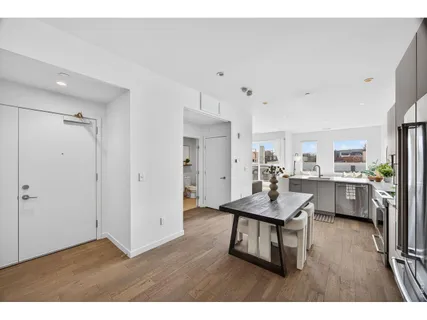 a kitchen with a sink cabinets and a large window