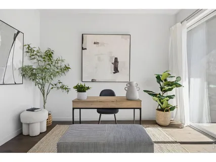a bedroom with a bed and painting on the wall