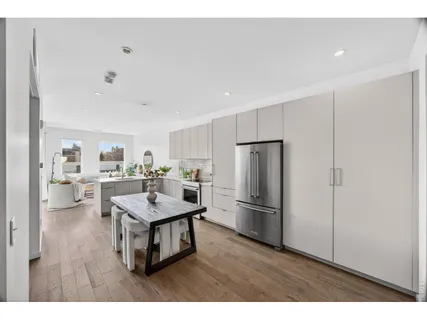 a kitchen with stainless steel appliances granite countertop a refrigerator a sink dishwasher a stove with wooden floor