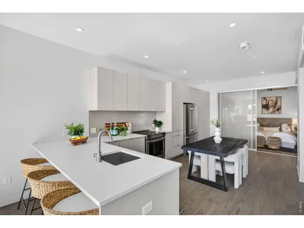 a kitchen with a stove a refrigerator and a sink