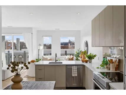 a kitchen with refrigerator and cabinets