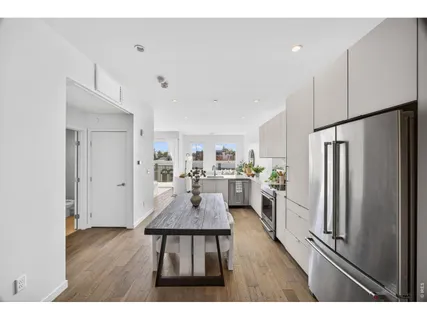a kitchen with stainless steel appliances granite countertop a stove a refrigerator a sink a counter space and cabinets
