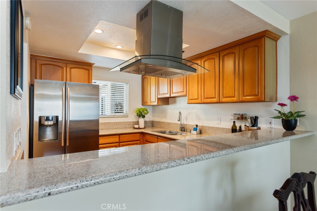 726 Elm Avenue, Unit 404 Long Beach, CA 90813 - Photo 7 of 31 a kitchen with stainless steel appliances granite countertop a sink and a refrigerator