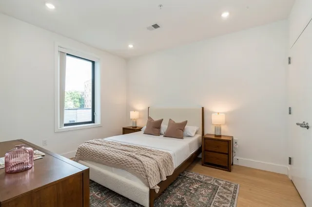 a bedroom with a bed and a mirror