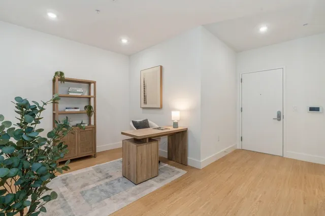 a view of a kitchen with cabinets and wooden floor
