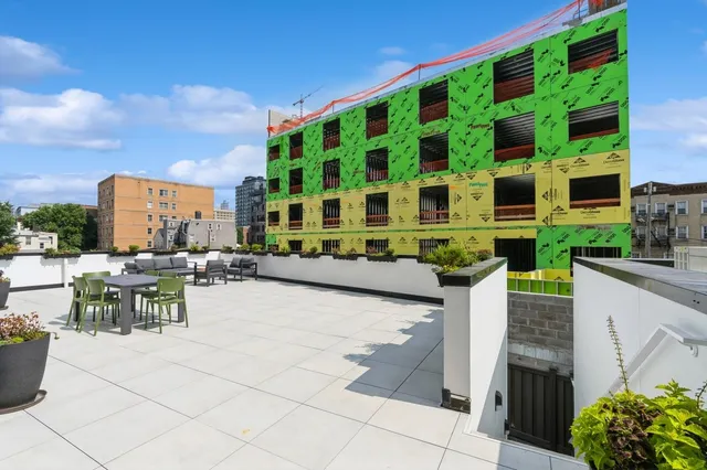 a view of city from terrace with seating area