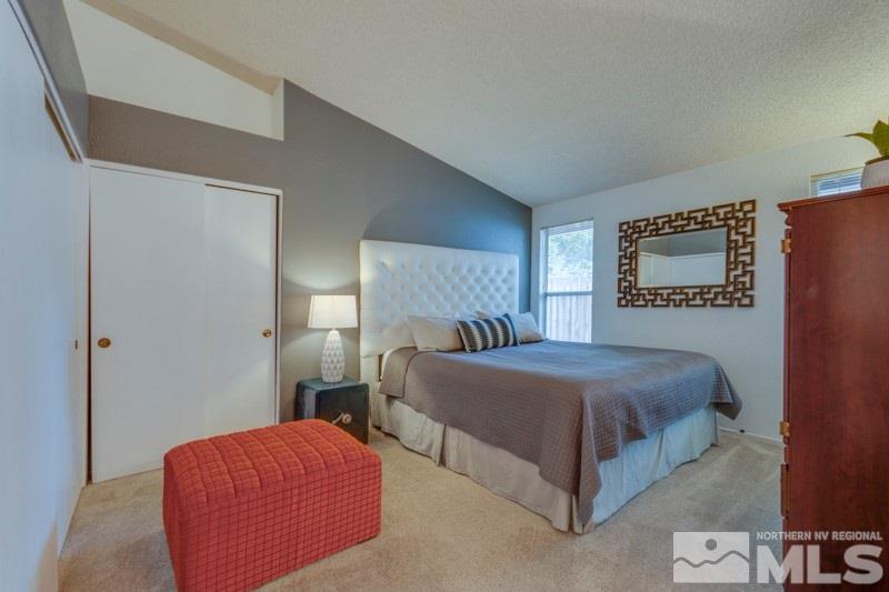 6006 White Water Way Reno, NV 89523 - Photo 11 of 20 a bedroom with a bed and a lamp