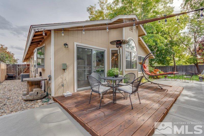 6006 White Water Way Reno, NV 89523 - Photo 19 of 20 a view of a patio with table and chairs with wooden floor and fence