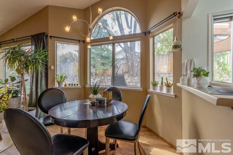 6006 White Water Way Reno, NV 89523 - Photo 7 of 20 a dining room with furniture a chandelier and wooden floor