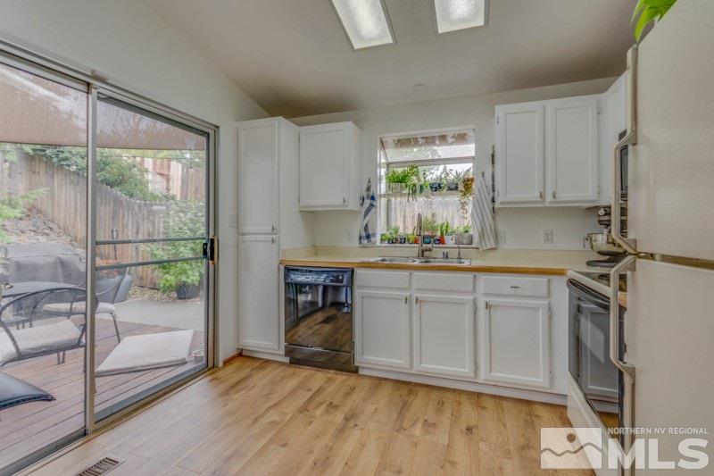 6006 White Water Way Reno, NV 89523 - Photo 9 of 20 a kitchen with a refrigerator a sink and cabinets