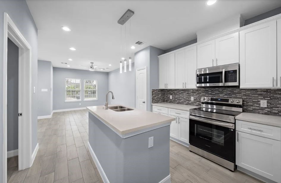 5222 Bataan Road Houston, TX 77033 - Photo 4 of 22 Designer kitchen with premium finishes, oversized island, and a sophisticated open-concept layout.