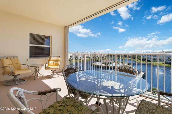 a balcony with table and chairs