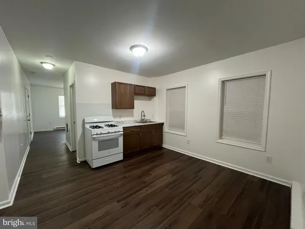 a kitchen with stainless steel appliances kitchen island granite countertop a stove a sink and a microwave