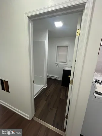 a view of a hallway and wooden floor