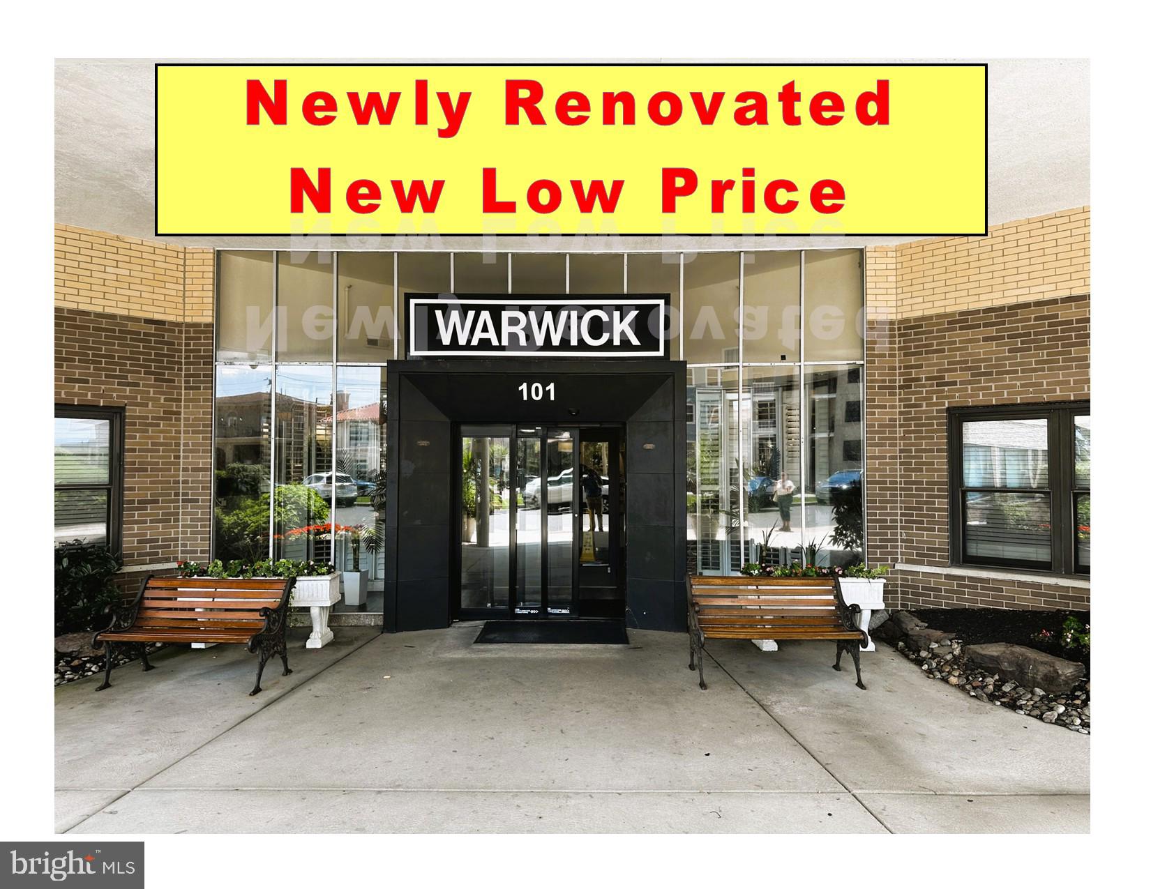 a black and white building with outdoor seating