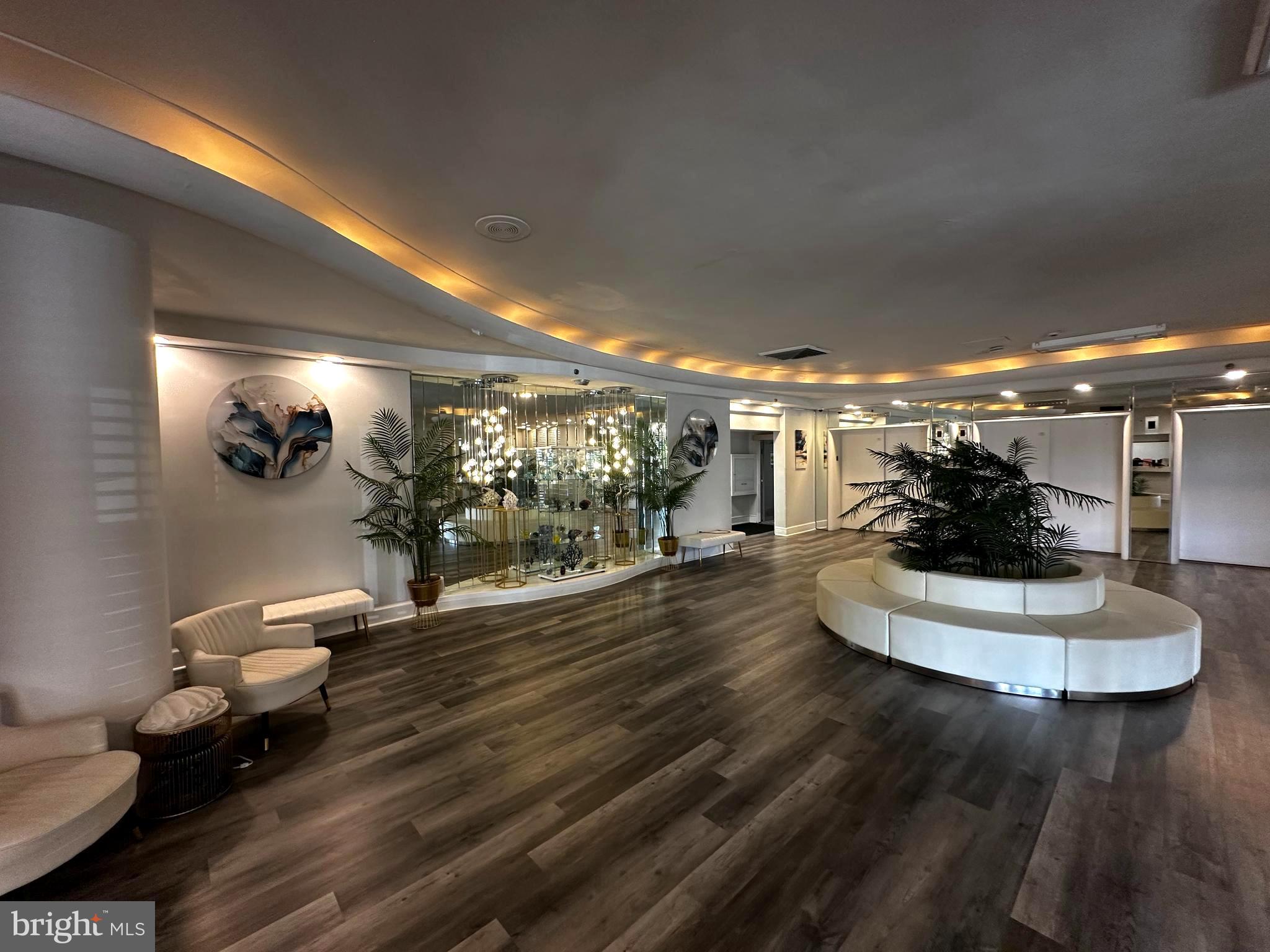 101 South Raleigh Avenue Atlantic City, NJ 08401 - Photo 12 of 18 a room with lots of white furniture and a chandelier