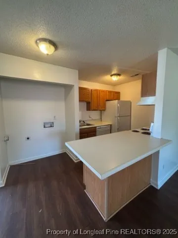 a view of kitchen with wooden floor
