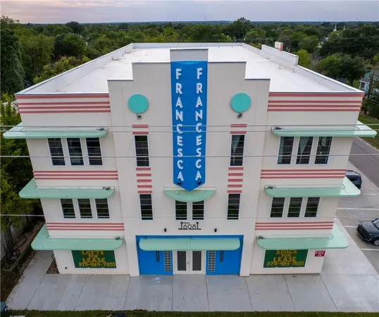 a aerial view of residential houses with yard and mountain view in back