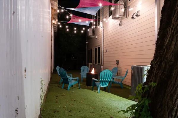 a view of a house with backyard and sitting area