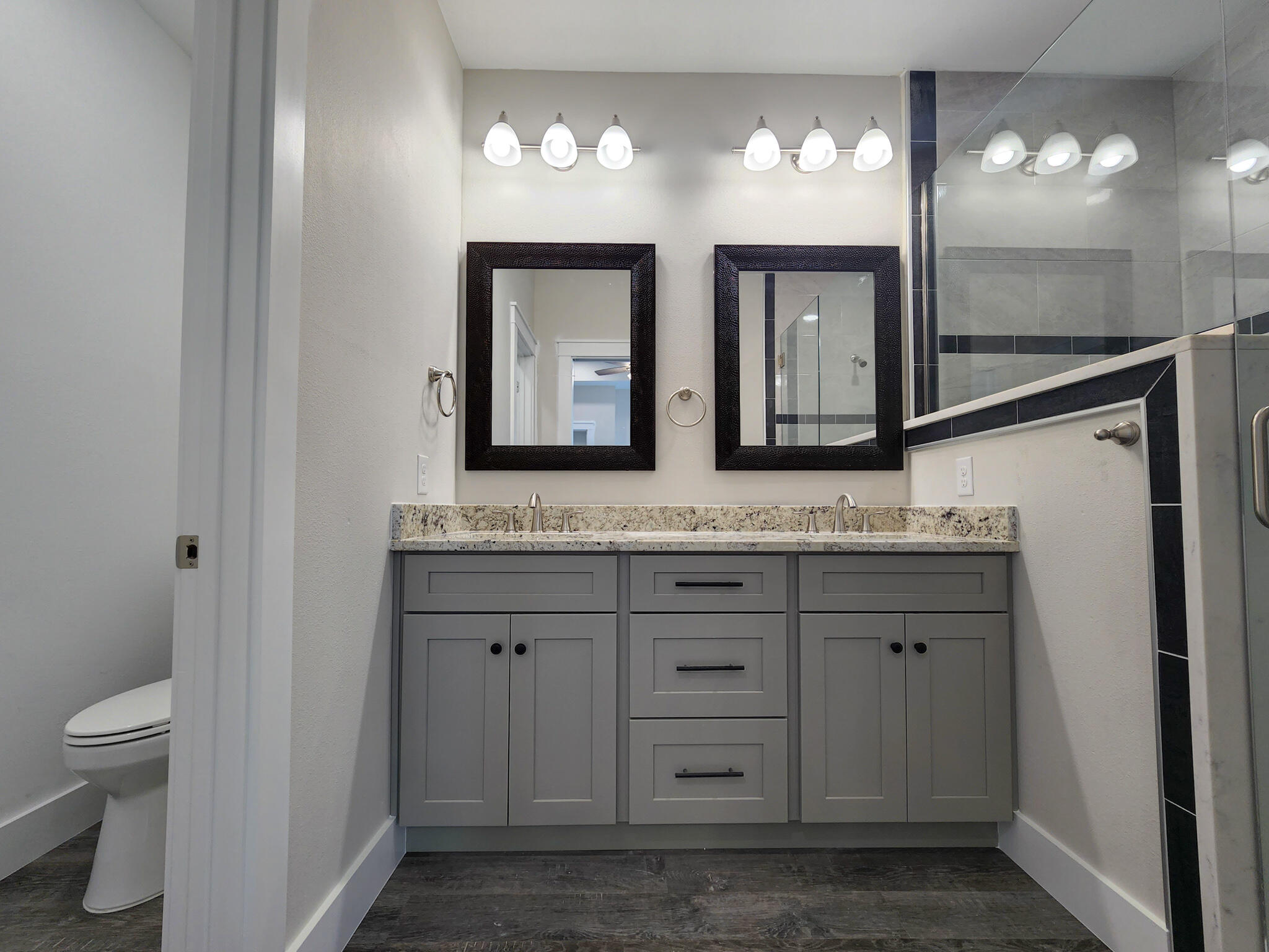 2199 Paloma Street Navarre, FL 32566 - Photo 15 of 27 a bathroom with a granite countertop sink a toilet and a mirror