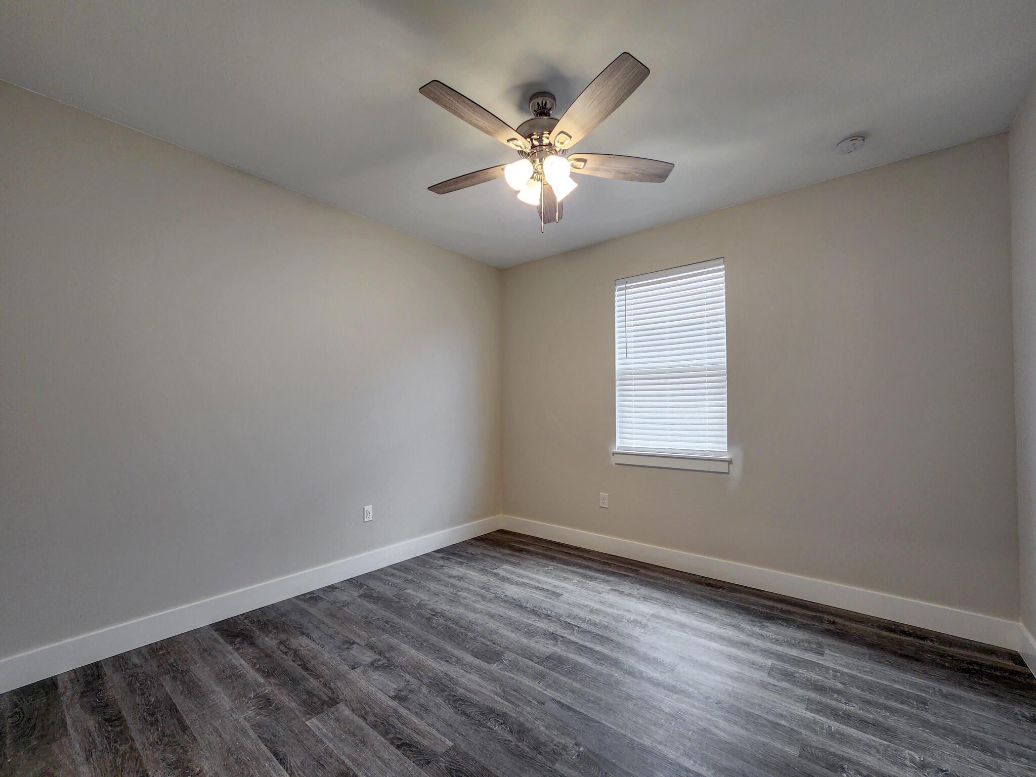 2199 Paloma Street Navarre, FL 32566 - Photo 17 of 27 an empty room with wooden floor fan and windows