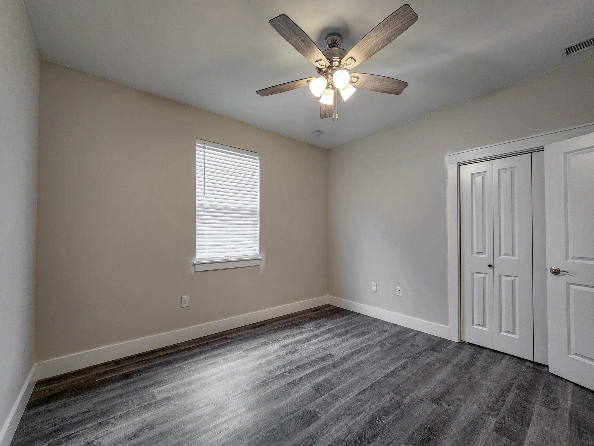 2199 Paloma Street Navarre, FL 32566 - Photo 18 of 27 an empty room with wooden floor and windows