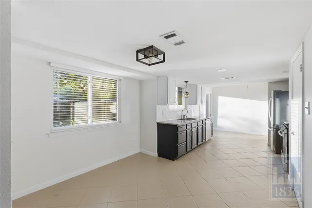 a view of kitchen with furniture and refrigerator