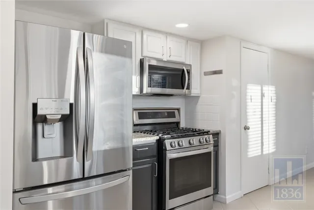 a kitchen with stainless steel appliances a refrigerator stove and microwave