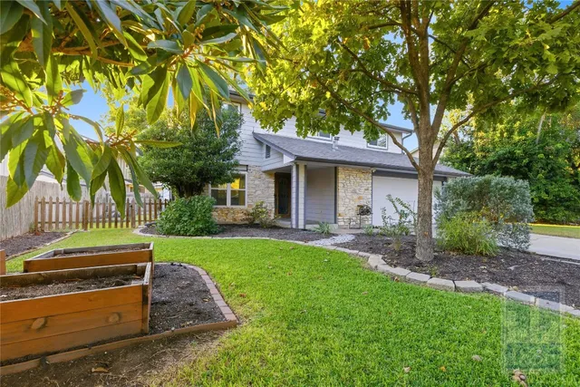 front view of a house with a tree